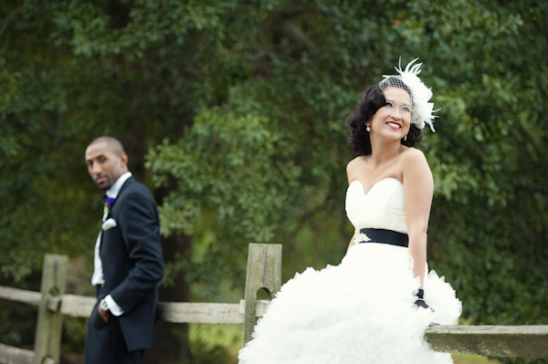 bride and groom posing on fence - wedding photo by top Atlanta based wedding photographers Scobey Photography